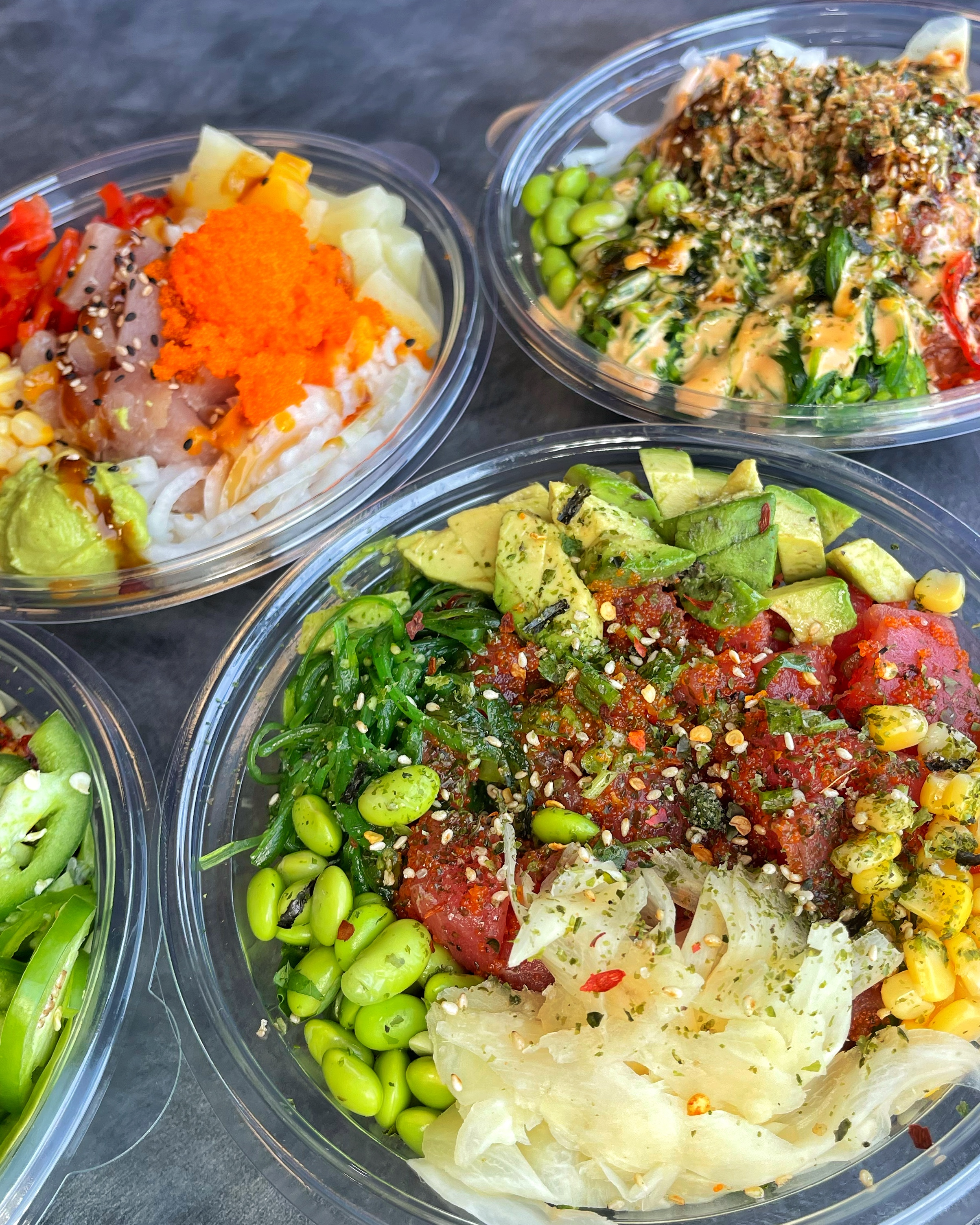 Customers enjoying two poke bowls from Mono Poke