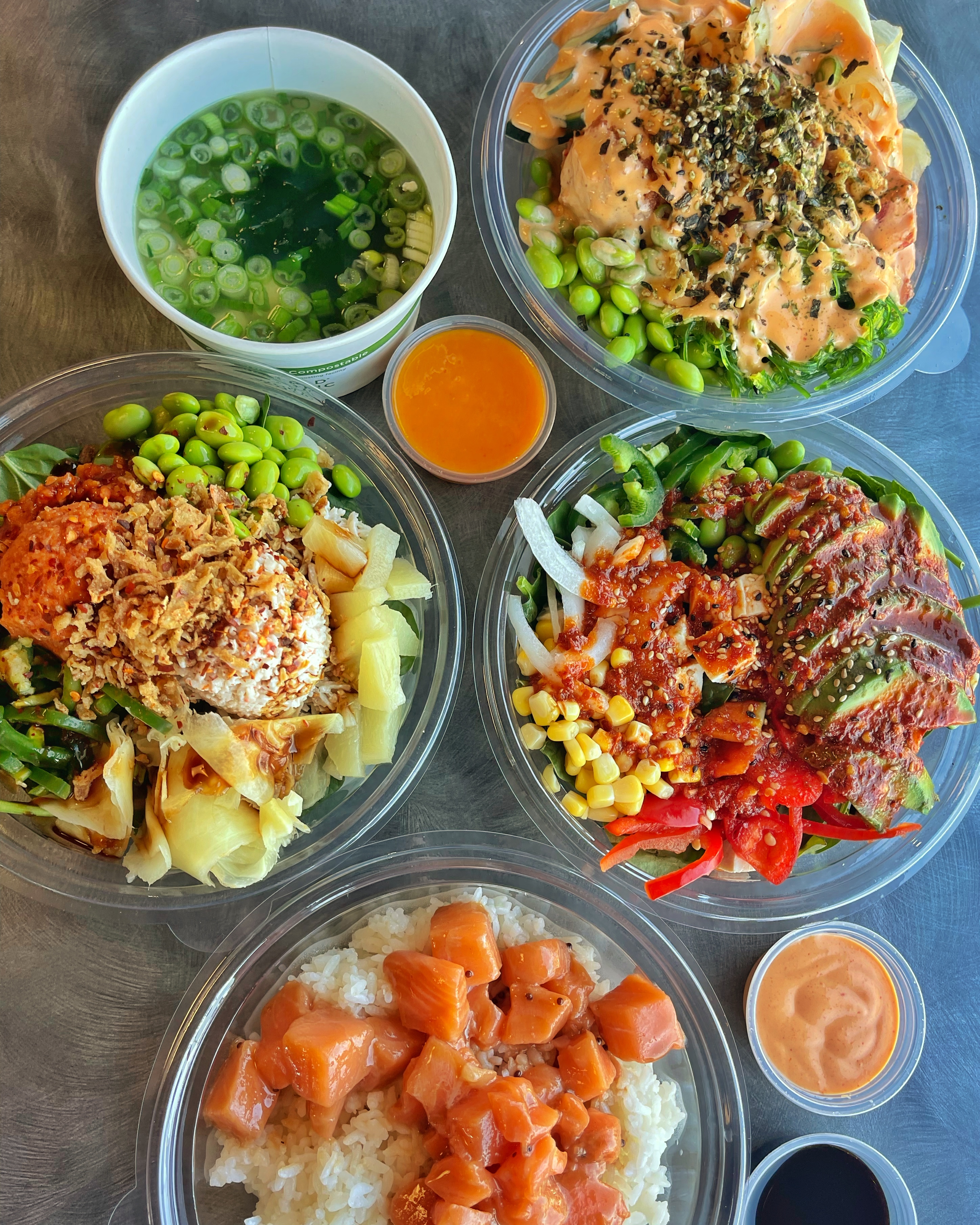 Four poke bowls with sauce on the side from MonoPoke